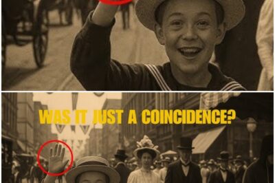 A boy waves at the camera in 1909 — but when they zoom in on the corner of the photo, they realize..